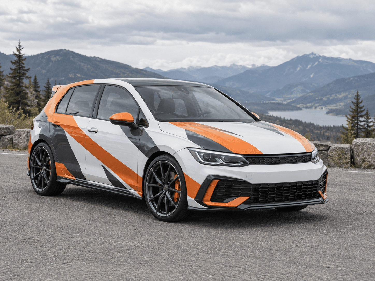 White hatchback with orange and charcoal rally-inspired car wrap graphics