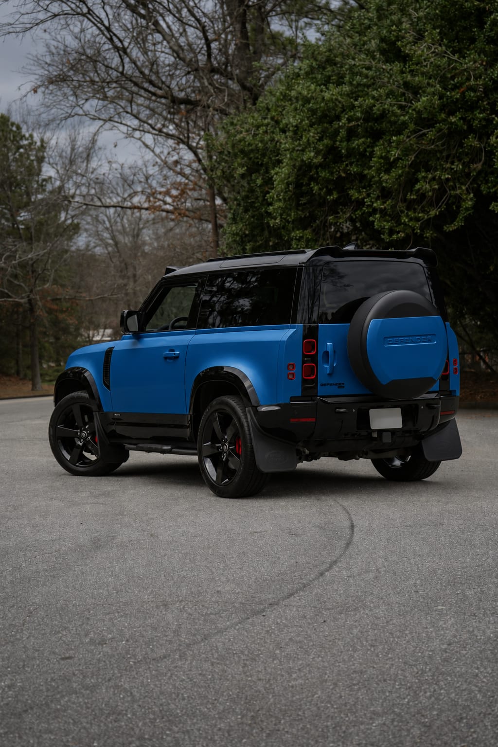 AI wrap concept of the same Land Rover Defender in satin ocean blue