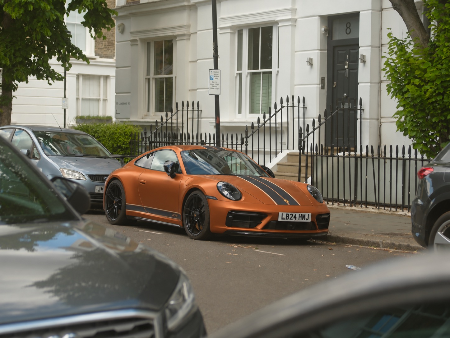 AI wrap concept of the same Porsche 911 with satin copper paintwork and charcoal racing stripes